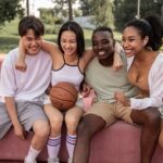 A group of people sitting on a bench with a basketball Description automatically generated with medium confidence